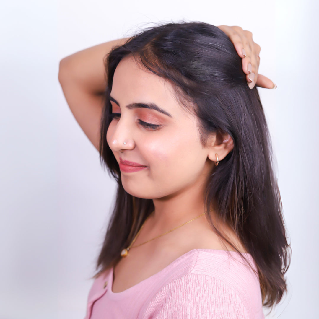 Smiling woman showcasing natural-looking hair, ideal for demonstrating the seamless blend of Hairarchy's premium hair extensions or toppers, set against a clean white background to emphasize the product's quality and style.